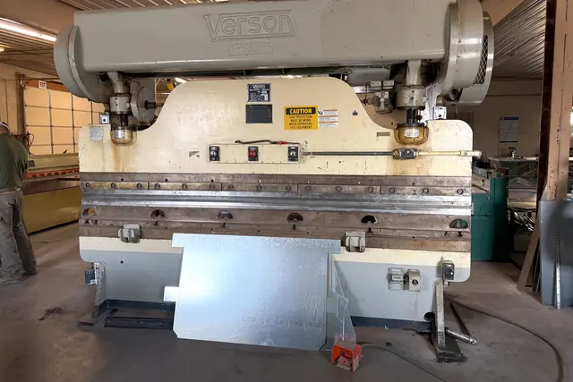 The shop's Verson press brake with a sheet of galvanized steel loaded in it.