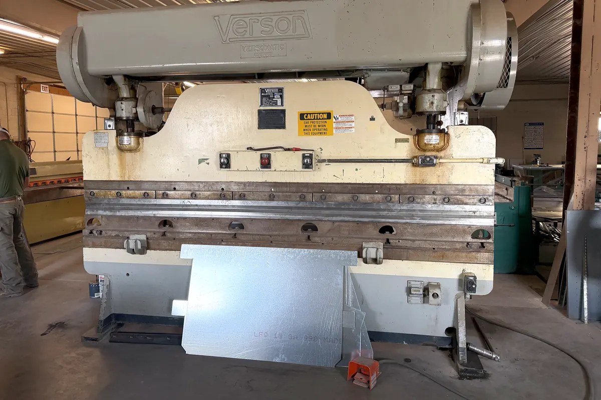 The shop's Verson press brake with a sheet of galvanized steel loaded in it.