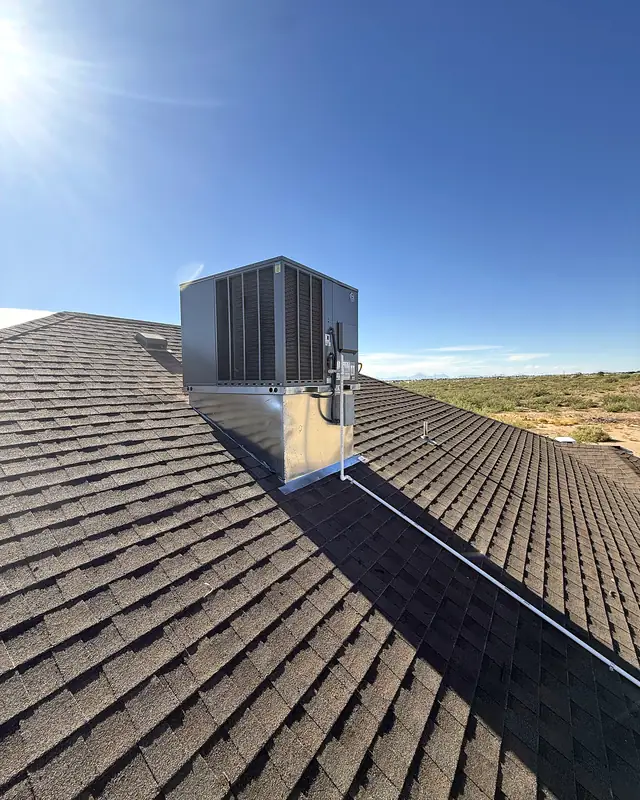 The new rooftop unit seen from further down the roof, with the desert beyond.